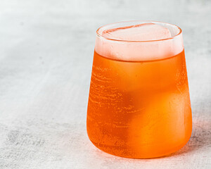 refreshing drink with orange garnish
