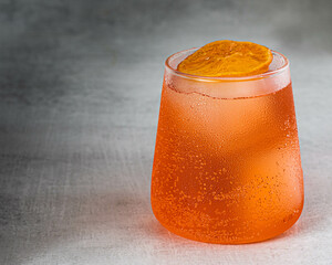 refreshing drink with orange garnish