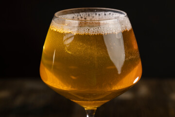 yellow apple juice in a clear glass with bubbles
