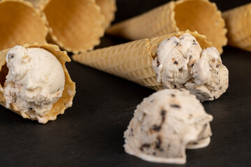 creamy ice cream with pieces of chocolate on a black slate