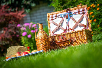 Picnic basket on green sunny lawn in the park