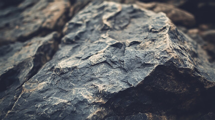 A close-up photo of a rough, black rock. The photo has a vintage look and would be perfect for a poster or banner background.
