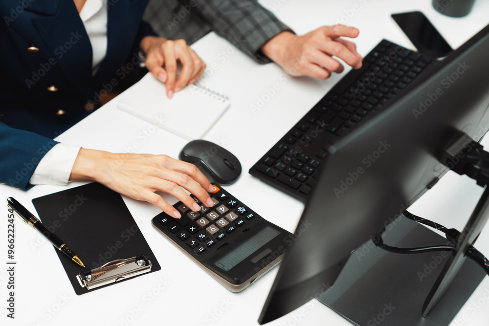 Poster cropped hands businessman with coworker calculating with calculator manual's financial and accountin