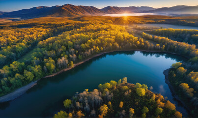 Obraz premium An aerial view of a serene lake surrounded by autumn foliage, bathed in the warm glow of sunrise