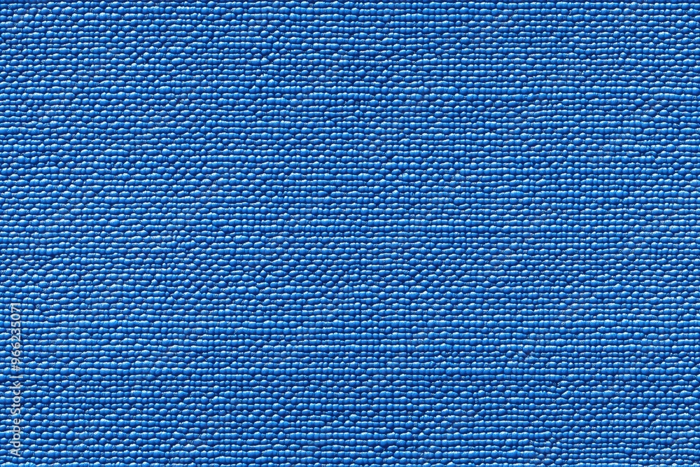 Poster textured blue yoga mat, showcasing a woven pattern with small raised dots. the fabric appears durabl