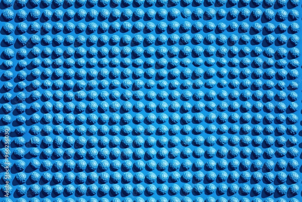 Poster a textured blue yoga mat surface featuring numerous small, raised bumps arranged in a grid pattern. 