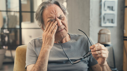 Old man with eye fatigue	