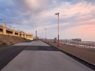 Obraz premium the seafront promenade in north Blackpool with the tower and town buildings in the distance and the north pier at low tide