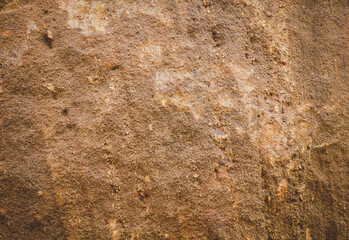 Brown rough sandstone wall for abstract background and texture for interior or exterior design. Beautiful patterns, space for work, banner, wallpaper close up.