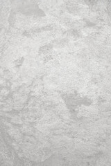 Light grey rough stone wall for abstract background and texture for interior or exterior design. Beautiful patterns, space for work, banner, wallpaper close up.Vertical.