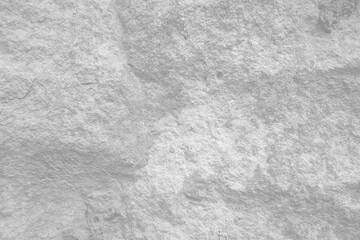 Light grey rough stone wall for abstract background and texture for interior or exterior design. Beautiful patterns, space for work, banner, wallpaper close up.