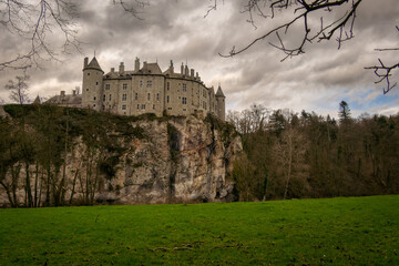 landscape photograph of the castle of Walzin situated on the heights of a hill romantic castle presenting a beautiful facade under a gray autumn sky