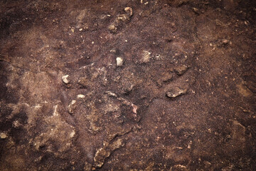 Brown black rough stone wall for abstract background and texture for interior or exterior design. Beautiful patterns, space for work, banner, wallpaper close up.