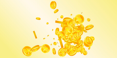 Chinese yuan coins falling. Scattered gold CNY