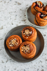 Cruffings with salted caramel and with cherry filling on a plate