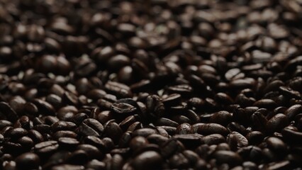 Close up of fresh brown coffee bean with roasted smoke from pile of coffee beans. Macrography of hot coffee seed with fragrant and scented hot smoke come from pile of bean. Top down view. Comestible.