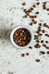 Coffee beans in a cup and around