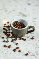 Coffee beans in a cup and around