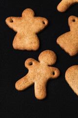 Festive gingerbread cookies on black background