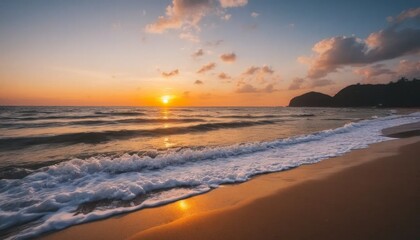 Soft Blue Waves on a Sandy Beach at Sunset
