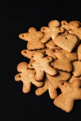 Festive gingerbread cookies on black background