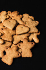 Festive gingerbread cookies on black background