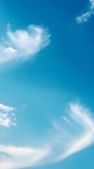 A clear blue sky with a few wispy clouds, providing an airy and light backdrop for various design projects,No blurriness