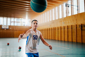 Young player passing basketball indoors