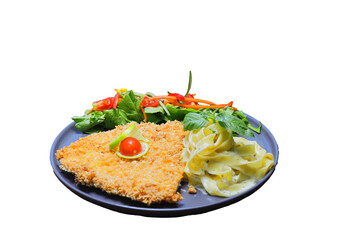Chicken schnitzel with salad and pasta on the wooden background. With white wine.