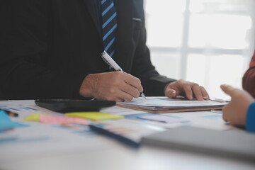 Meeting of business executives discussing analysis of the company's financial situation and business planning with partner collaboration and consultation of strategy.