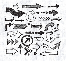 Collcetion of hand-drawn arrows in various styles and directions, sketched with a rough, artistic feel on old paper background