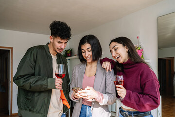 Friends Laughing and Enjoying Wine Together
