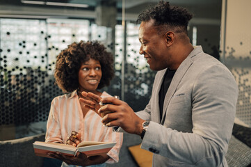 Diverse businesspeople discussing tasks and assignments at office.