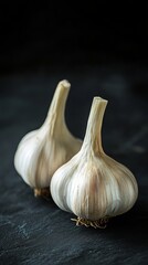 Garlic bulbs on dark background, rustic kitchen concept