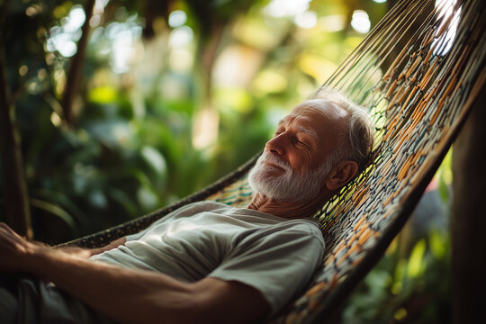 Senior man relaxing in a hammock outdoors with eyes closed