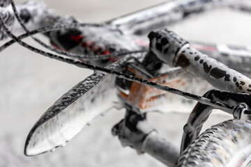 A bike with a white foam covering on the handlebars and seat