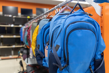 A rack of backpacks in a store