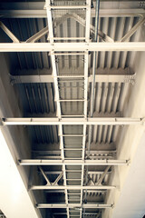 Fototapeta premium towering bridge with a steep stairway, designed for workers to access the upper levels. It symbolizes human engineering, teamwork, and the pursuit of progress