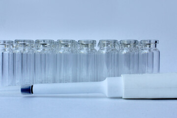 New glass vials for instrumental analysis on a white background. analytical vials prepared for...