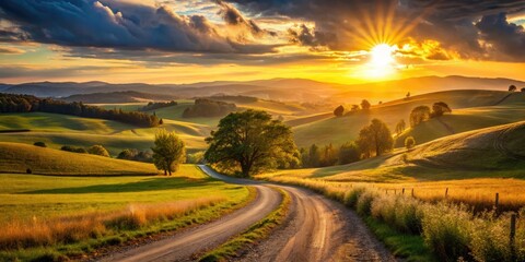 Obraz premium A serene, golden-lit sunset casts a warm glow on a tranquil, peaceful rural landscape with rolling hills, trees, and a winding dirt road.