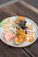 Hot fried Sushi roll with salmon, chives and cheese.