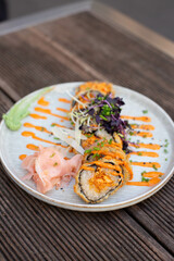 Warm tempura sushi roll with seafood.