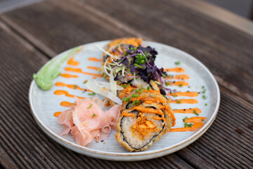 Warm tempura sushi roll with seafood.