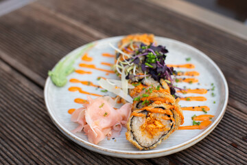 Hot fried Sushi roll with salmon, chives and cheese.