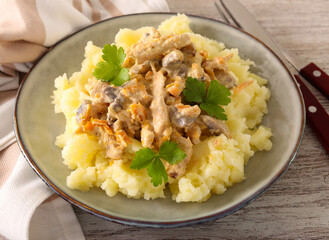 Chicken breast with mushrooms in creamy sauce over mashed potatoes