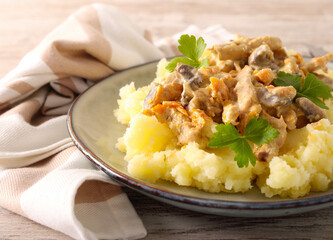 Chicken breast with mushrooms in creamy sauce over mashed potatoes