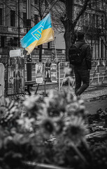 Berlin, Germany - August 4 2023: Unknown, unidentifiable man walks past Ukrainian flag outside the Russian Embassy in Berlin.