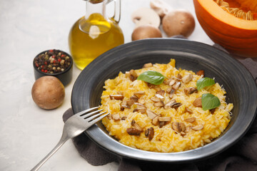 Risotto with pumpkin and mushrooms close-up on a white background, close-up