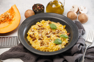 Risotto with pumpkin and mushrooms close-up on a white background, close-up