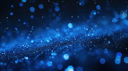 Obraz premium Scattered deep blue particles against a dark backdrop create a striking, festive design element